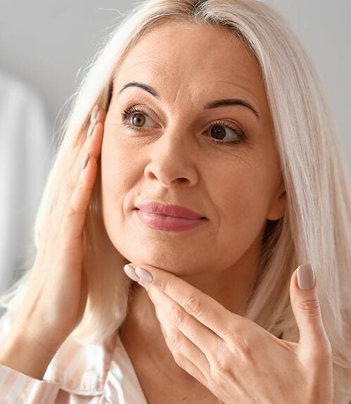 Woman with smooth, youthful facial contours after a deep plane facelift in San Antonio