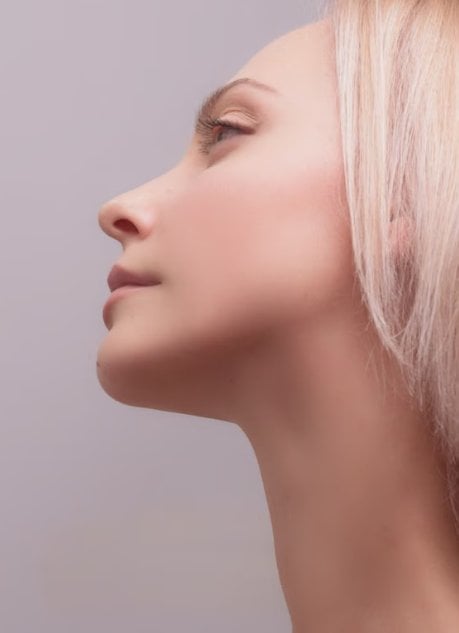 Profile of a woman's jawline and chin after chin augmentation