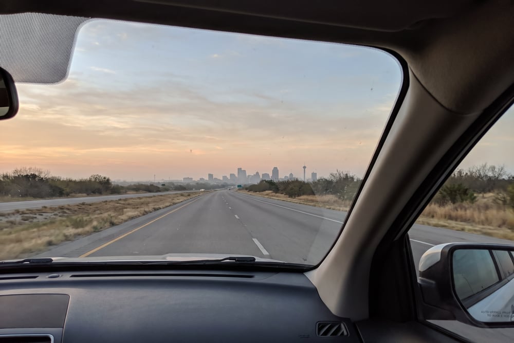 A passenger view of the highway approaching San Antonio, Texas